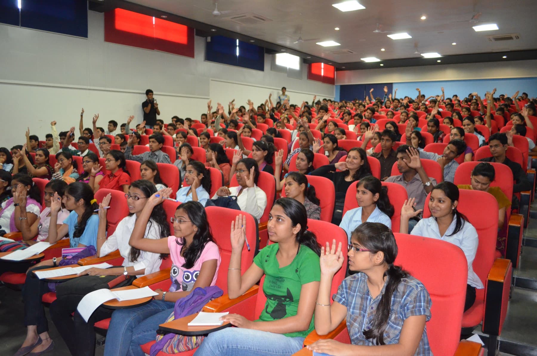 Students raising their hands during a workshop